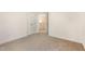 This bedroom features neutral walls, plush carpeting, a closet, and a door to the hallway at 46 Lupin Dr, Smithfield, NC 27577