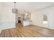 Open-concept dining area with modern chandelier and kitchen view at 46 Lupin Dr, Smithfield, NC 27577