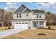 Charming two-story home with a two-car garage and stone accents at 46 Lupin Dr, Smithfield, NC 27577