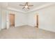 Spacious main bedroom with tray ceiling, fan, and large windows at 46 Lupin Dr, Smithfield, NC 27577