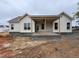 A view of the new construction home featuring a covered back porch with a ceiling fan installed at 47 Royal Ave, Selma, NC 27576