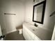Bathroom featuring a single sink vanity, large mirror, and a toilet with a built in bidet at 47 Royal Ave, Selma, NC 27576