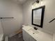 Bright bathroom with modern vanity, stylish mirror, and shower-tub combo at 47 Royal Ave, Selma, NC 27576