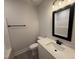 Clean bathroom featuring a vanity, modern lighting, framed mirror, and combination shower and tub at 47 Royal Ave, Selma, NC 27576