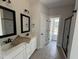Bathroom featuring double sink vanity, black framed mirrors and a glass shower enclosure at 47 Royal Ave, Selma, NC 27576