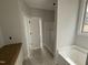 Bathroom with a bathtub and shower, featuring neutral walls, a vanity, and an open doorway at 47 Royal Ave, Selma, NC 27576