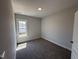Cozy bedroom featuring neutral walls, carpeting, a single window, and trim work around the base of the wall at 47 Royal Ave, Selma, NC 27576