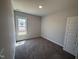 Cozy bedroom with carpet flooring, natural lighting, and neutral paint at 47 Royal Ave, Selma, NC 27576