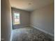 Cozy bedroom with a single window, neutral color and ample natural light at 47 Royal Ave, Selma, NC 27576