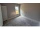 Bedroom with neutral paint, base trim, and a window providing natural light at 47 Royal Ave, Selma, NC 27576