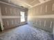 Unfinished bedroom showing the blank canvas of this home's potential with a window for natural light at 47 Royal Ave, Selma, NC 27576