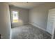 Bedroom with one window, neutral paint, and a door to the rest of the home at 47 Royal Ave, Selma, NC 27576