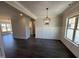 Elegant dining room with stylish chandelier, wainscoting, and dark hardwood flooring at 47 Royal Ave, Selma, NC 27576