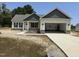 Charming one-story home showcasing a welcoming front entrance and an attached two-car garage at 47 Royal Ave, Selma, NC 27576