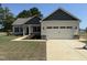 Charming home featuring a two-car garage, stylish green and white siding, and a well-maintained front yard at 47 Royal Ave, Selma, NC 27576