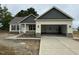 Charming, single-story home with a two-car garage, stone accents, and covered front porch at 47 Royal Ave, Selma, NC 27576