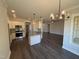Modern kitchen featuring granite countertops, stainless steel appliances, pendant lighting and hardwood floors at 47 Royal Ave, Selma, NC 27576