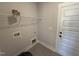 Utility room with tile flooring, overhead shelving, and modern hookups at 47 Royal Ave, Selma, NC 27576