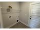 Functional laundry room with tile flooring, shelving, and washer/dryer connections at 47 Royal Ave, Selma, NC 27576
