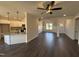 Open-concept living space showcasing hardwood floors, wainscoting, natural light, and views of the kitchen at 47 Royal Ave, Selma, NC 27576