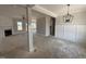 Spacious living room with a fireplace, decorative pillars and large windows letting in natural light at 47 Royal Ave, Selma, NC 27576