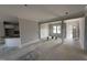 Living room with white trim, neutral paint, and an adjacent kitchen and entry at 47 Royal Ave, Selma, NC 27576