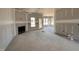 View of the living room with fireplace, awaiting finishing touches at 47 Royal Ave, Selma, NC 27576