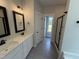 Elegant main bathroom with dual sinks, a tiled floor, and a glass-enclosed shower at 47 Royal Ave, Selma, NC 27576