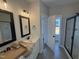 Main bathroom featuring dual vanities, tile floors, and glass-enclosed shower at 47 Royal Ave, Selma, NC 27576