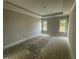 Main bedroom features a tray ceiling, two windows, and neutral paint at 47 Royal Ave, Selma, NC 27576