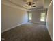 Spacious main bedroom with tray ceiling, plush carpeting, two windows, and ample natural light at 47 Royal Ave, Selma, NC 27576