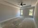 Bedroom featuring tray ceiling, large windows, and space for a king-sized bed at 47 Royal Ave, Selma, NC 27576