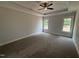 Inviting main bedroom featuring a tray ceiling, neutral colors, and natural light at 47 Royal Ave, Selma, NC 27576