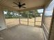 A screened-in porch with ceiling fan offers an outdoor seating area with backyard views at 47 Royal Ave, Selma, NC 27576
