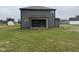 Side view of home from backyard with green siding and covered porch at 48 Silver Ct, Smithfield, NC 27577