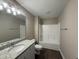 Bright bathroom features granite vanity, tub/shower, and dark wood-look flooring at 48 Silver Ct, Smithfield, NC 27577