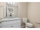 Modern bathroom featuring a granite countertop vanity and decorative mirror at 48 Silver Ct, Smithfield, NC 27577