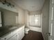 Bathroom featuring granite vanity top, tiled shower and vinyl floors at 48 Silver Ct, Smithfield, NC 27577