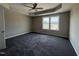 Bedroom with neutral walls, ceiling fan, tray ceiling, carpet flooring, and natural lighting at 48 Silver Ct, Smithfield, NC 27577