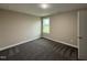 Neutral bedroom with gray carpet, window, cream walls and white trim at 48 Silver Ct, Smithfield, NC 27577