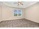 Bedroom features a ceiling fan, carpet flooring, and a window view of the neighborhood at 48 Silver Ct, Smithfield, NC 27577