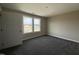 Bedroom with plush carpeting, neutral paint, and natural light from large windows at 48 Silver Ct, Smithfield, NC 27577