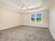This bedroom features carpet flooring, a ceiling fan, and a window with a neighborhood view at 48 Silver Ct, Smithfield, NC 27577