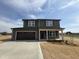Two story home with dark siding, stone accents, a two-car garage and a well manicured lawn at 48 Silver Ct, Smithfield, NC 27577