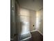 Laundry room with neutral walls, tile flooring, and storage shelf at 48 Silver Ct, Smithfield, NC 27577