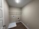A utilitarian laundry room with luxury vinyl tile and neutral paint at 48 Silver Ct, Smithfield, NC 27577