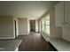 An open-concept room shows off the kitchen and living area's luxury vinyl flooring at 48 Silver Ct, Smithfield, NC 27577