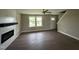 Spacious living room with luxury vinyl flooring, modern fireplace, and plenty of natural light at 48 Silver Ct, Smithfield, NC 27577