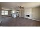 Open concept living room with hardwood floors, white cabinets, kitchen island and white fireplace at 48 Silver Ct, Smithfield, NC 27577