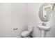 Cozy half-bathroom with a pedestal sink and a decorative oval mirror at 53 Barony Ln, Smithfield, NC 27577